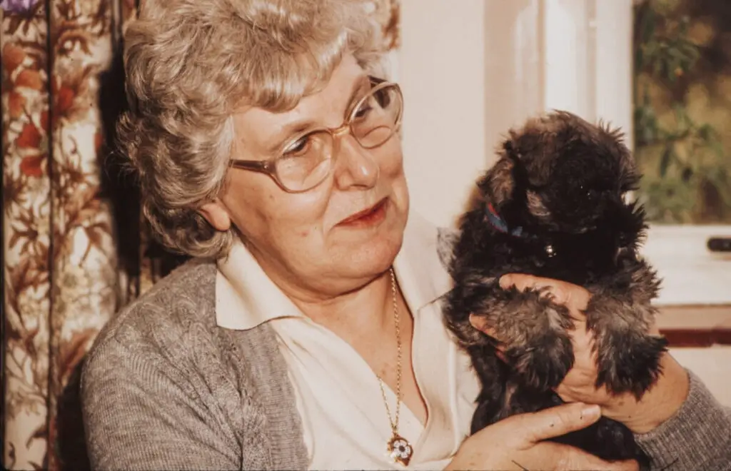 an example of an image to be shared at a memorial service of a grandmother holding her special lady - her puppy! 