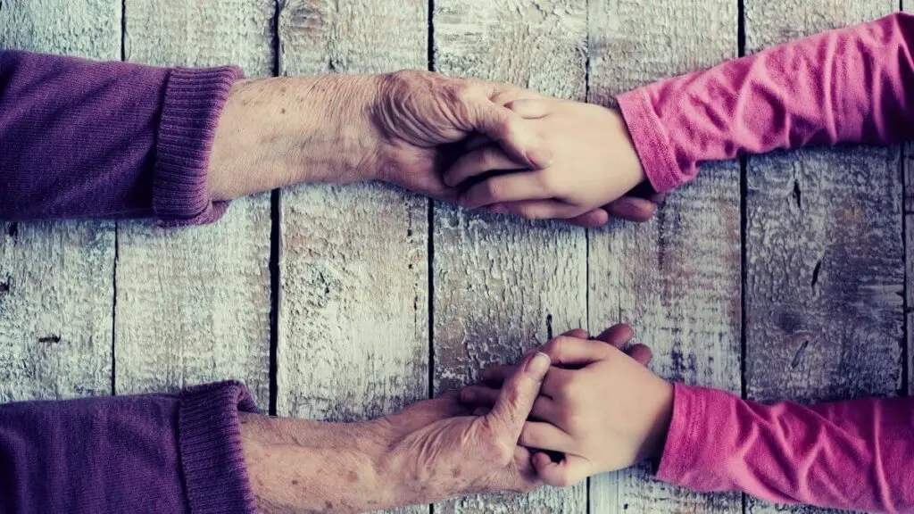 grandparent and grandchild holding hands before the grandmother passed away