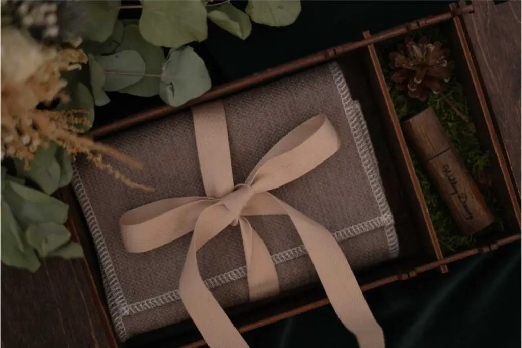 a beautifully wrapped gift (possibly a digital photo frame?), which is a symbol of timeless elegance 