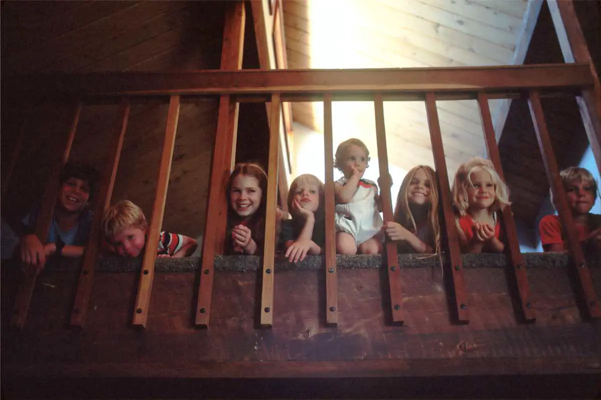 a bunch of children looking down from the second floor of a home - family photos can make great gifts as they carry special meaning of cherished memories and time spent with family member
