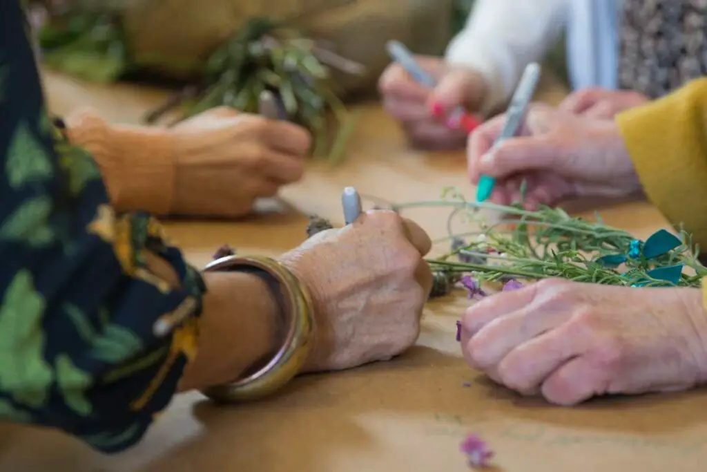 a group of people writing farewell words after the sudden passing of a kind spirit that will remain forever in their hearts