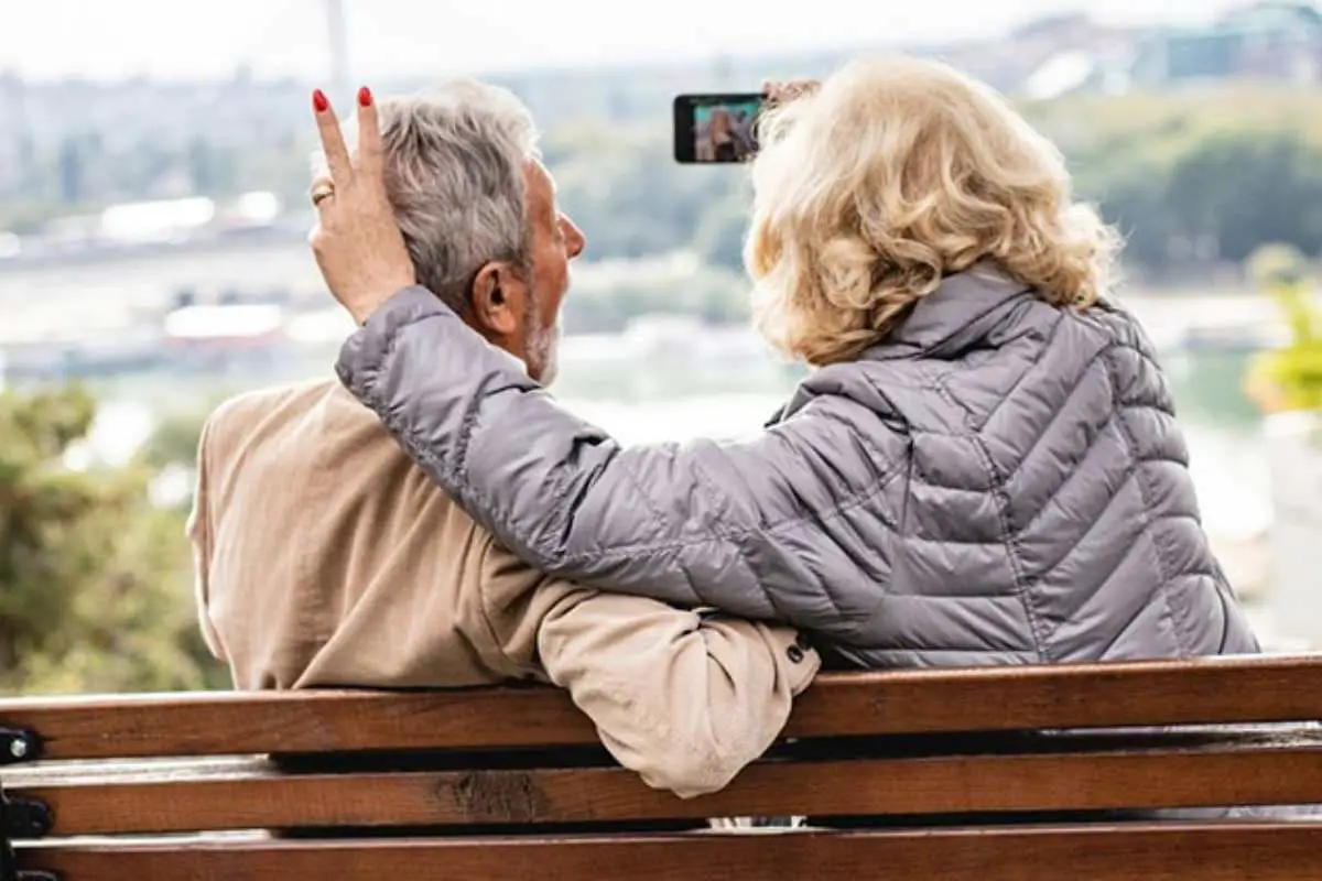 senior couple taking a selfie while living their best life doing some selfie poses